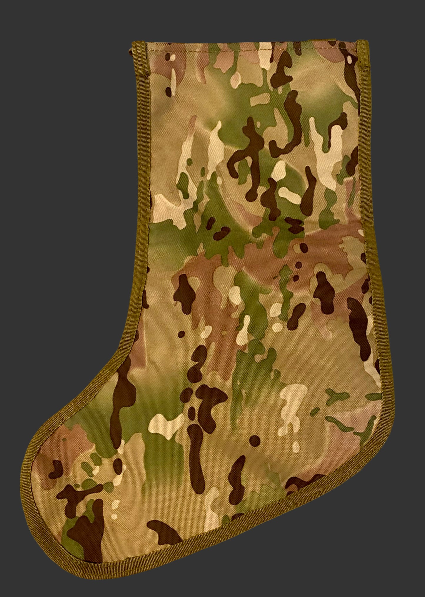 Camouflage-patterned Christmas stocking on a light background